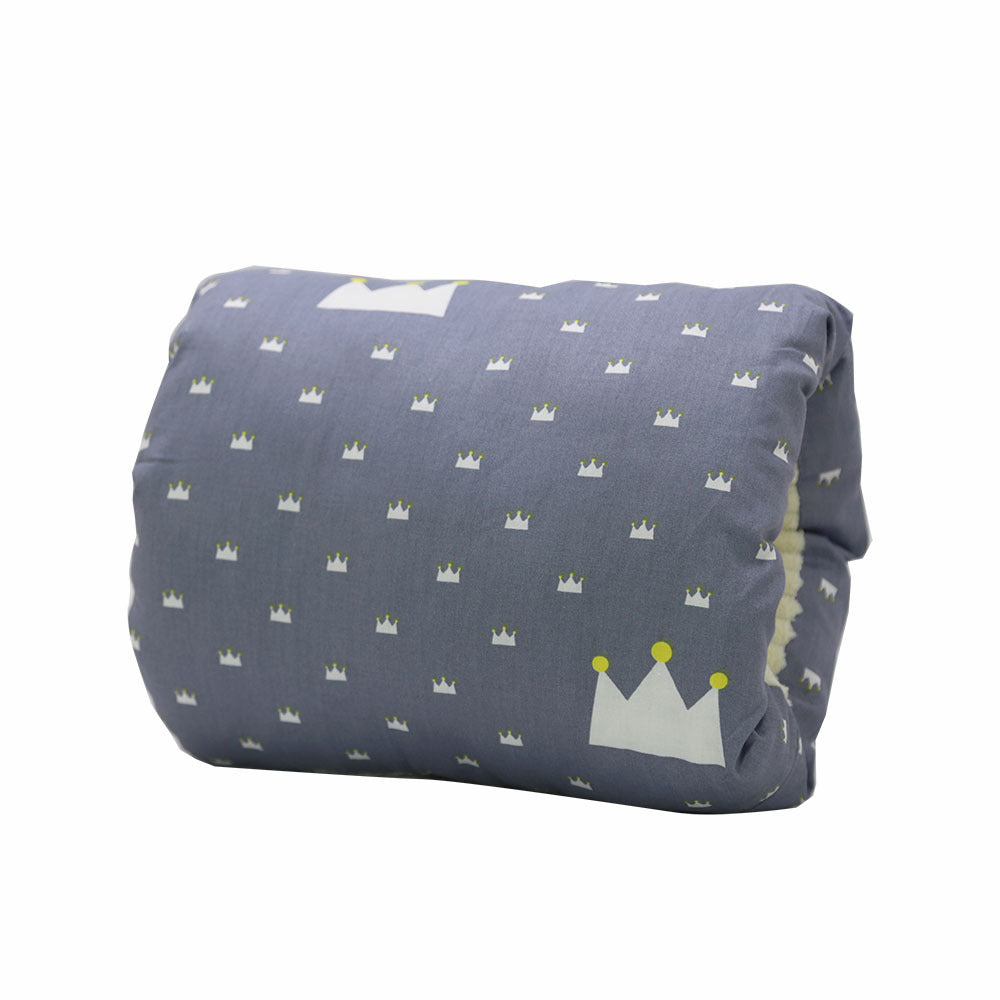 A blue fabric object with white crown patterns, featuring a large crown on the front corner. The fabric is folded, displaying a soft and cushioned texture.
