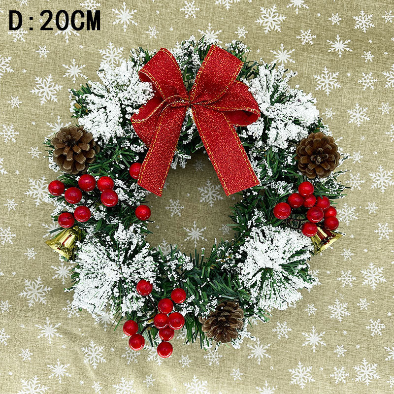 A 20cm Christmas wreath adorned with a red bow, pinecones, red berries, and snowy accents, set against a snowflake-patterned background.