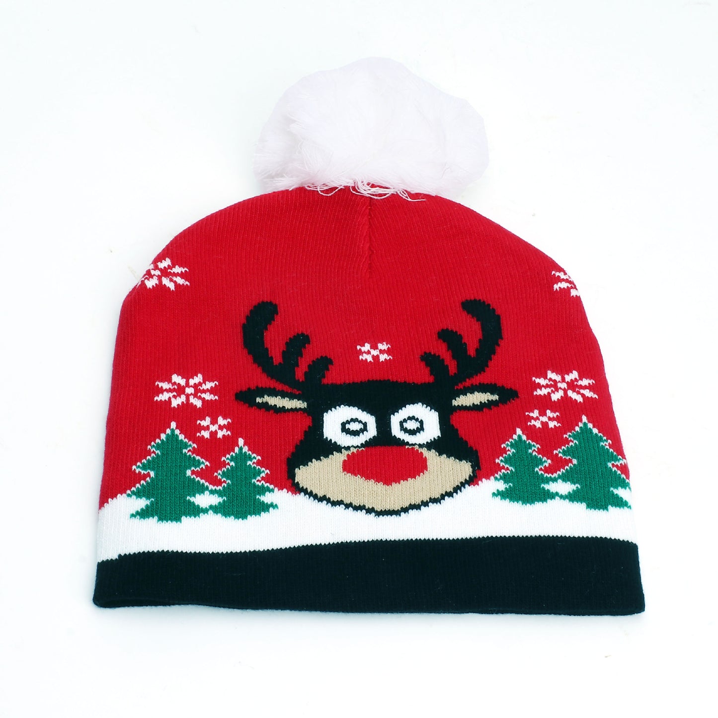 Red Christmas beanie with a reindeer face, snowflakes, and green trees. Topped with a white pom-pom.