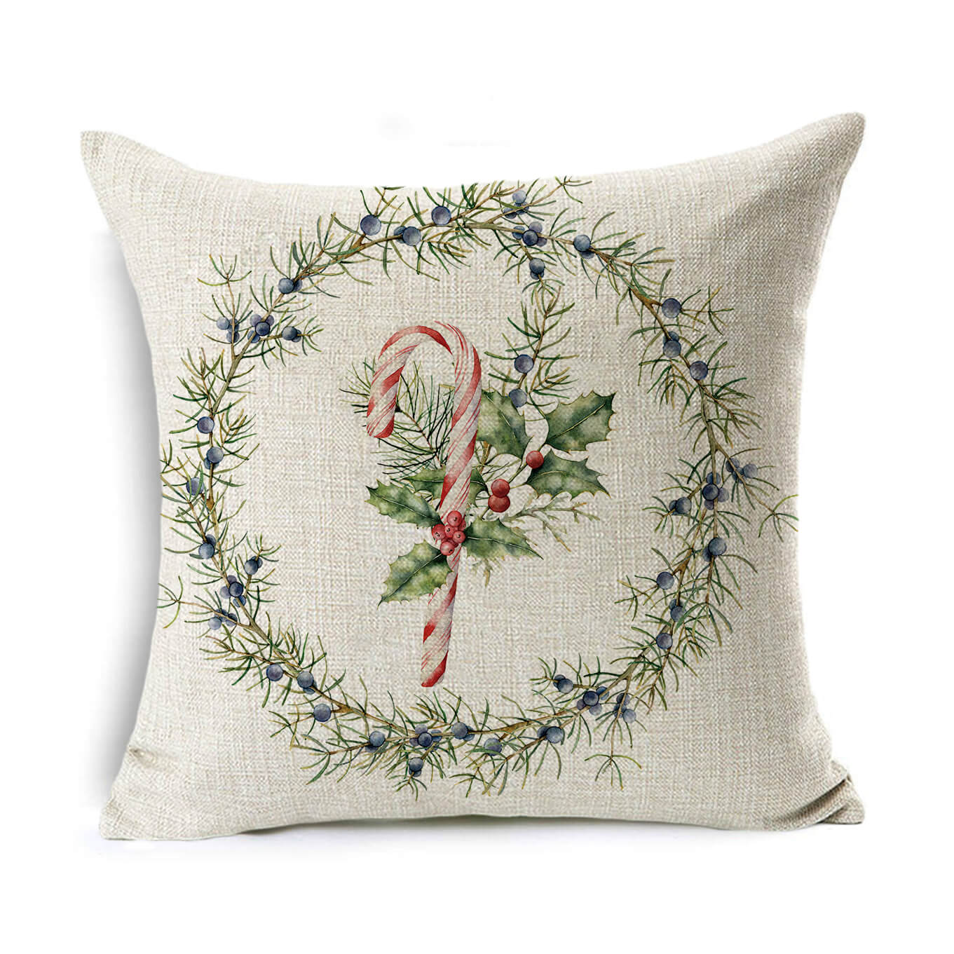 Festive pillow with a candy cane and holly design surrounded by a wreath of green foliage and blue berries on a textured beige background.