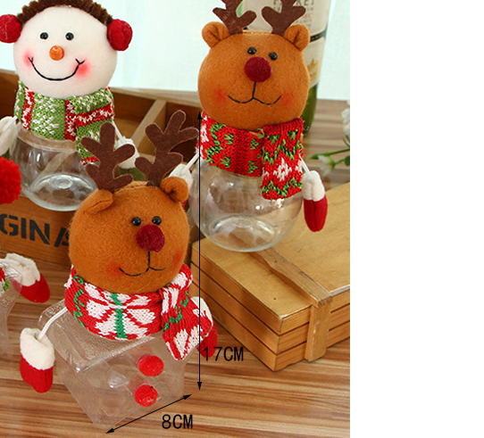 Plush reindeer and snowman ornaments with colorful scarves and earmuffs on a wooden surface. They feature transparent bodies with candy cane striped detailing.