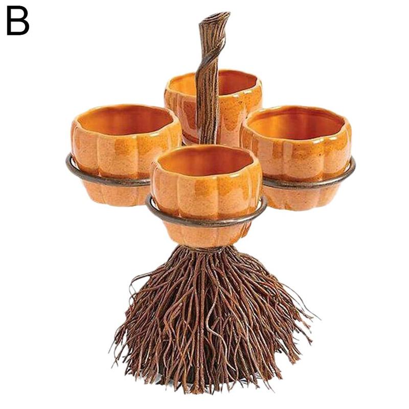 Orange pumpkin-shaped ceramic cups arranged on a metal stand resembling a broomstick. The stand features a twig-like texture, creating a Halloween-themed display.