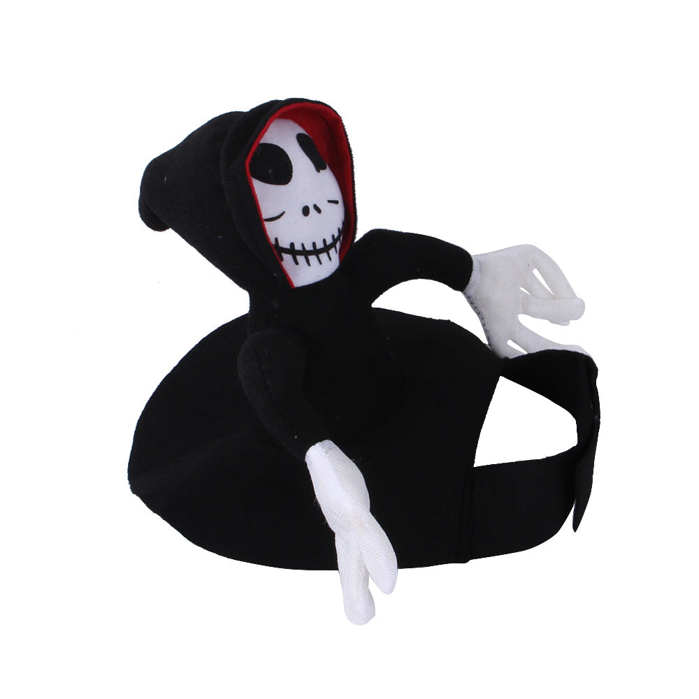 Plush Grim Reaper toy with a skull face, wearing a black hooded cloak lined with red and white gloves. The toy appears to be sitting with arms raised.