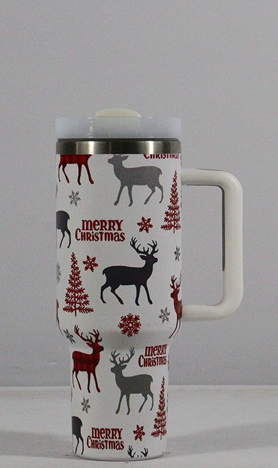 White travel mug with a handle, featuring red and gray reindeer, snowflakes, trees, and "Merry Christmas" text. The lid is gray and the mug is stainless steel at the top.
