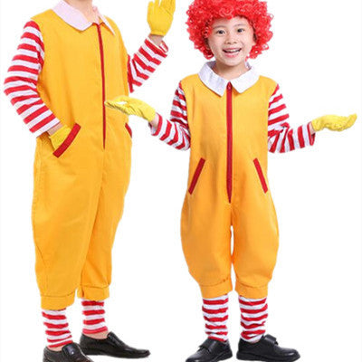 Two children in yellow clown costumes with red and white striped shirts and leggings, yellow gloves, and red wigs. They are smiling, with one waving at the camera.