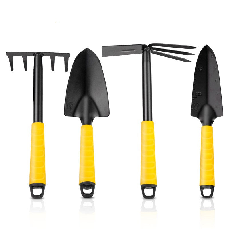 Set of four black gardening tools with yellow handles: a rake, a spade, a hoe, and a trowel. Each tool features a hanging loop at the end of the handle.