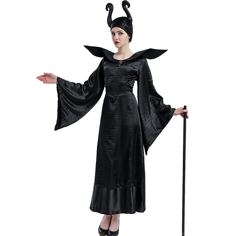 Person in a long, black, flowing gown with dramatic sleeves, horned headpiece, and a staff, resembling a fairy tale villain, against a plain white background.