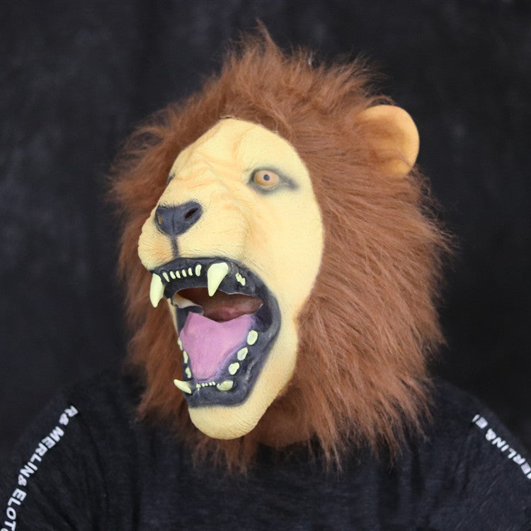 Person wearing a realistic lion mask with an open mouth, showing teeth and pink tongue. The mask features a detailed mane. The background is a plain dark color.