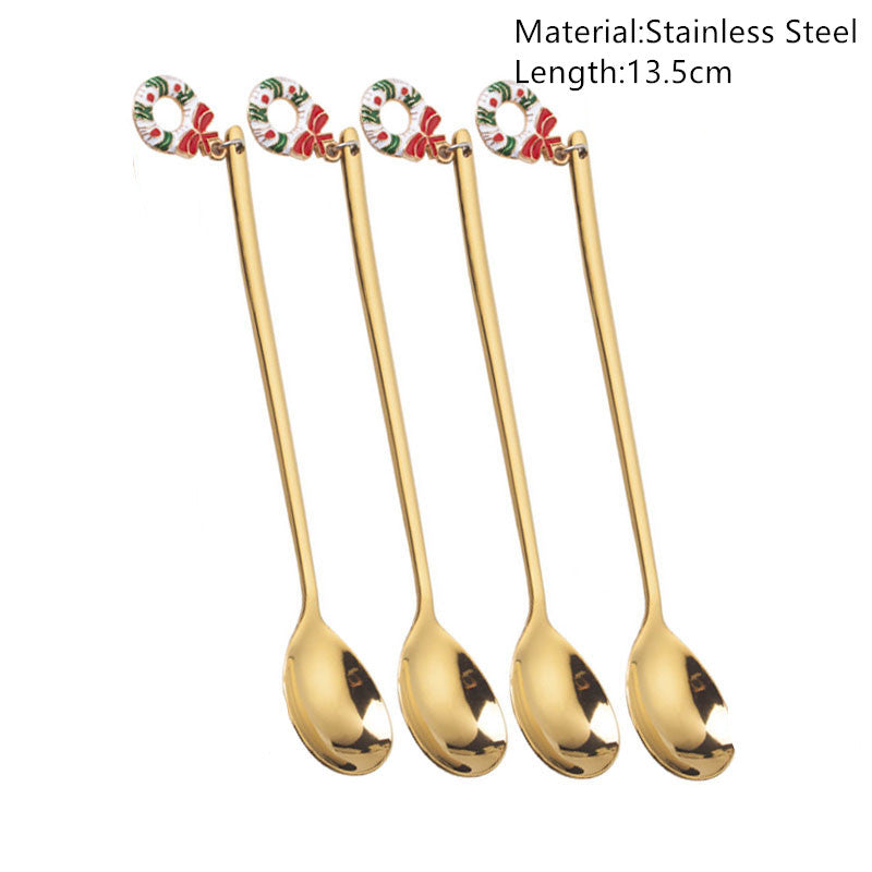 Four gold stainless steel spoons with long handles, each featuring a decorative floral design at the top. Text indicates material and length: 13.5 cm.