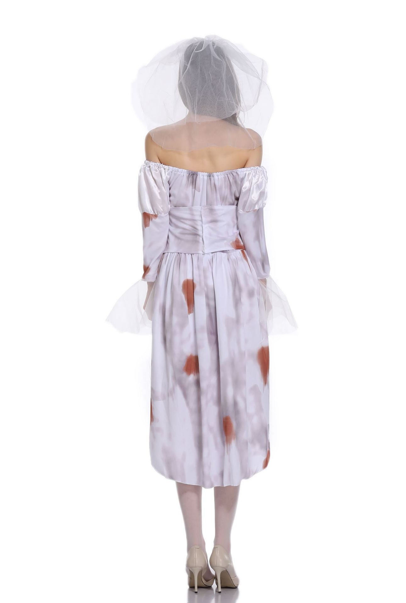 Rear view of a person wearing an off-shoulder, stained white dress with a sheer veil, standing on a reflective surface. The dress has long sleeves and a fitted waist.