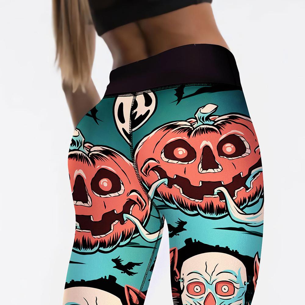 Close-up of leggings featuring a Halloween design with jack-o'-lanterns, bats, and ghoulish faces in vivid colors. The person is wearing a black crop top.