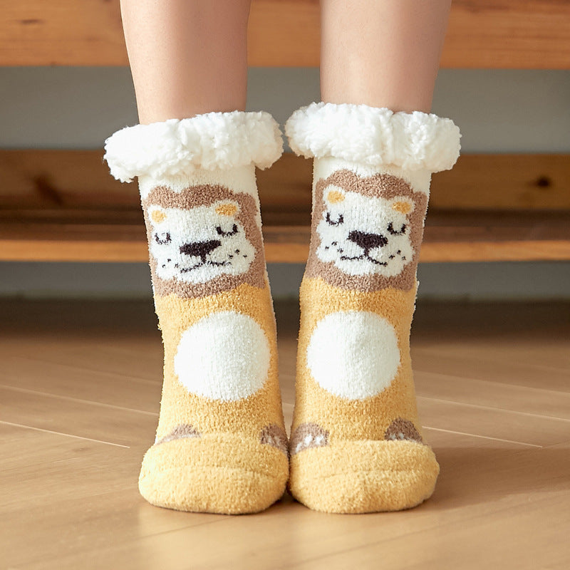 Fuzzy socks with cute lion faces and fluffy white cuffs are worn on wooden flooring, showcasing a playful and cozy design.