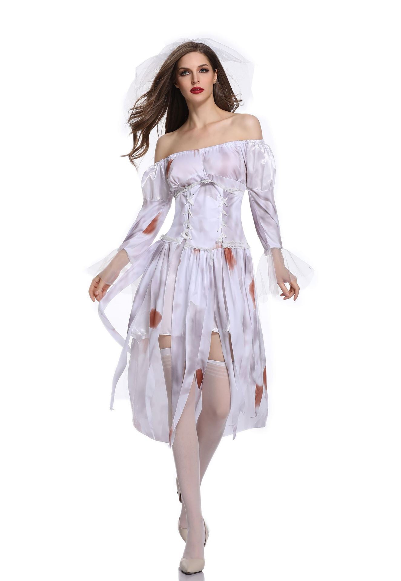 Woman in a tattered off-shoulder ghost bride costume with a corset and veil, adorned with reddish stains, walking forward with a confident expression against a white background.