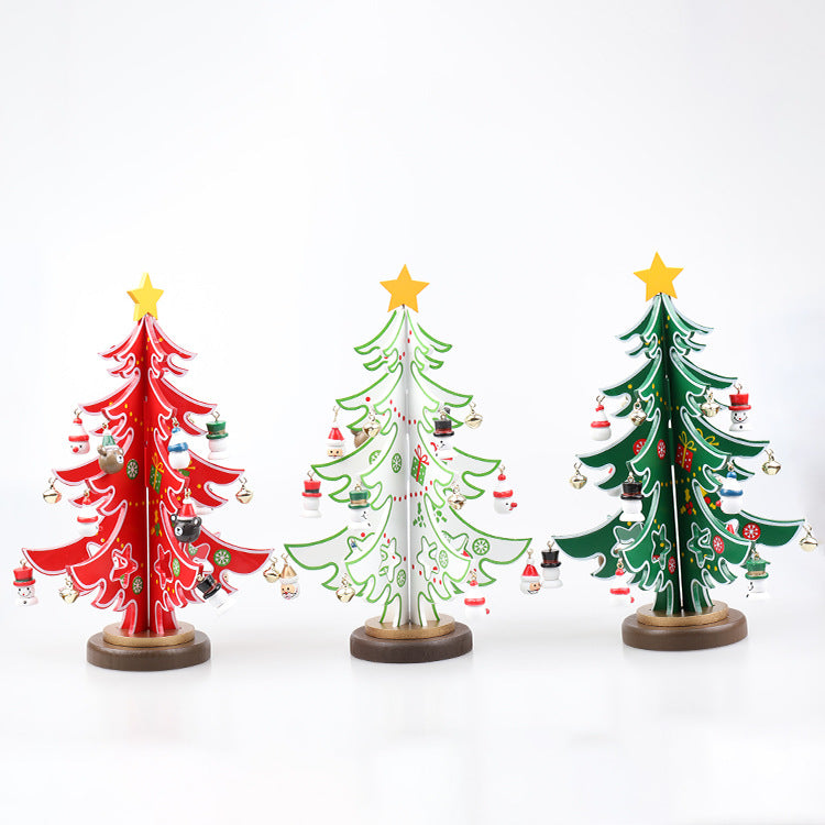 Three colorful decorative Christmas trees with gold stars on top, adorned with mini ornaments. They are red, white, and green, each standing on a wooden base.