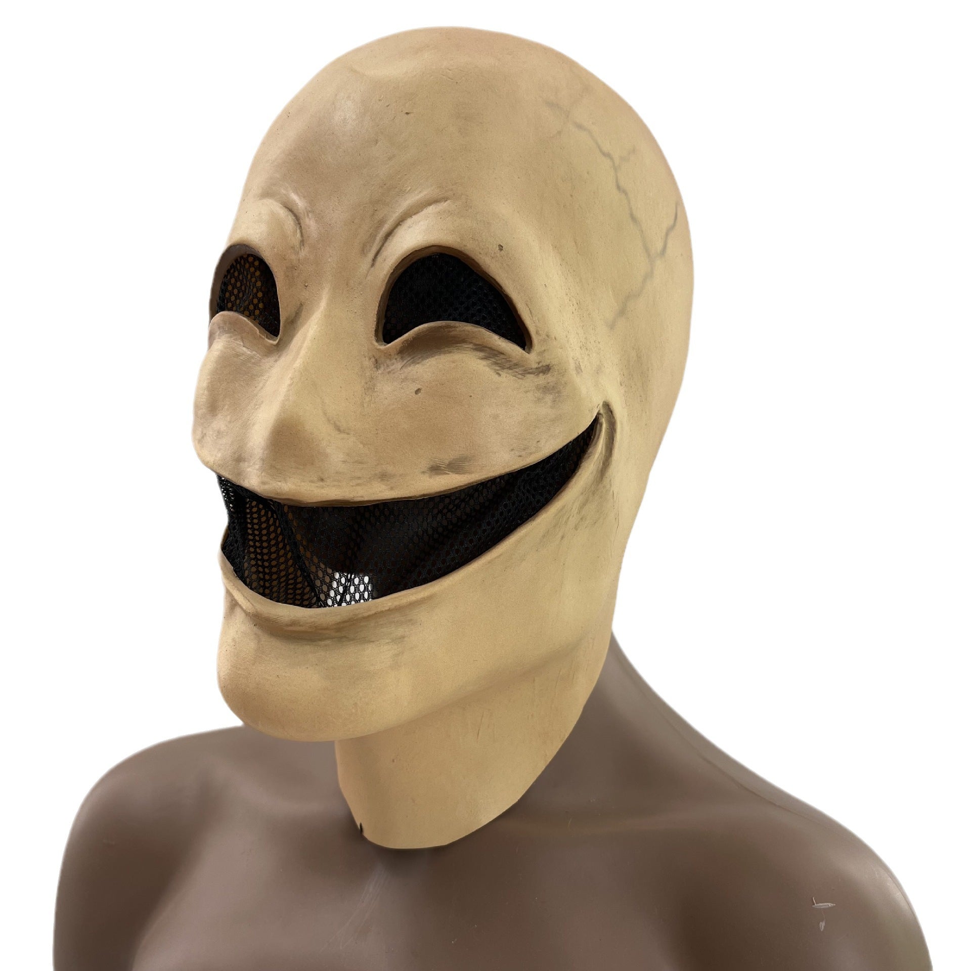 Creepy, smiling mask with exaggerated features and visible mesh eyes and mouth, set on a mannequin bust in a neutral color.