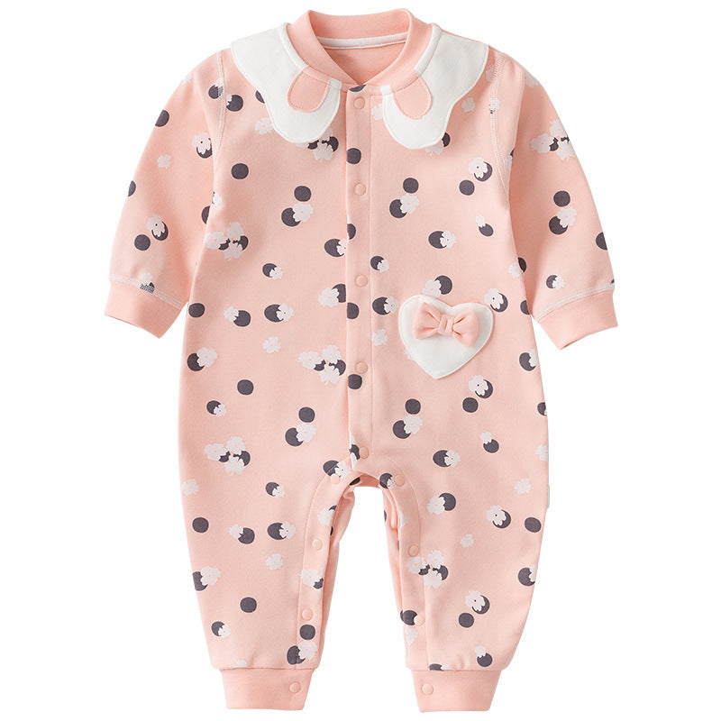 Peach baby onesie with a white collar, decorated with a polka dot and sheep pattern. Features a heart-shaped pocket with a bow and snap buttons down the front.