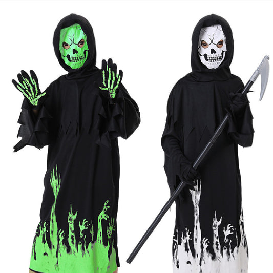 Two people in black hooded cloaks wear skull masks. One has glowing green skeletal hands, the other holds a scythe. Both have eerie green and white patterns at the robe's hem.