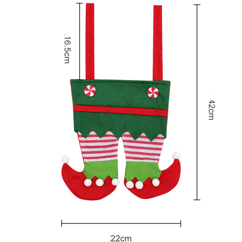 Festive green and red elf pants-shaped cutlery holder with peppermint buttons. Measurements: 42cm tall, 22cm wide, 16.5cm straps. Perfect for holiday table decor.