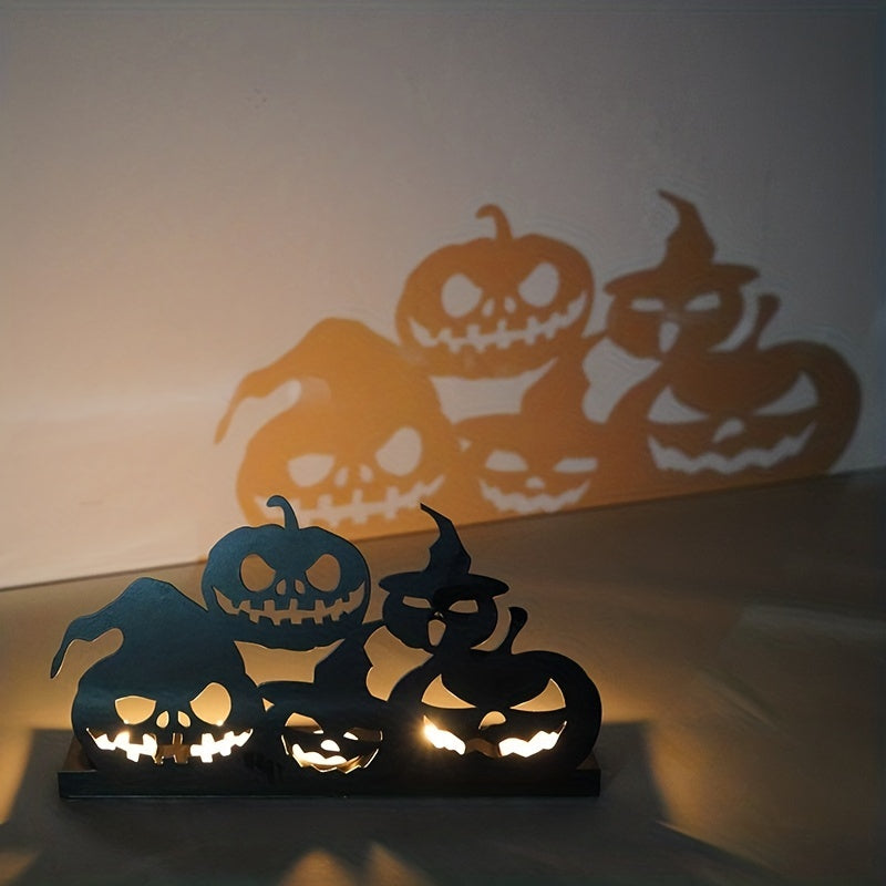 Halloween-themed metal candle holder with eerie carved jack-o'-lantern faces. The light casts spooky pumpkin shadows on the wall, creating a festive, haunting atmosphere.