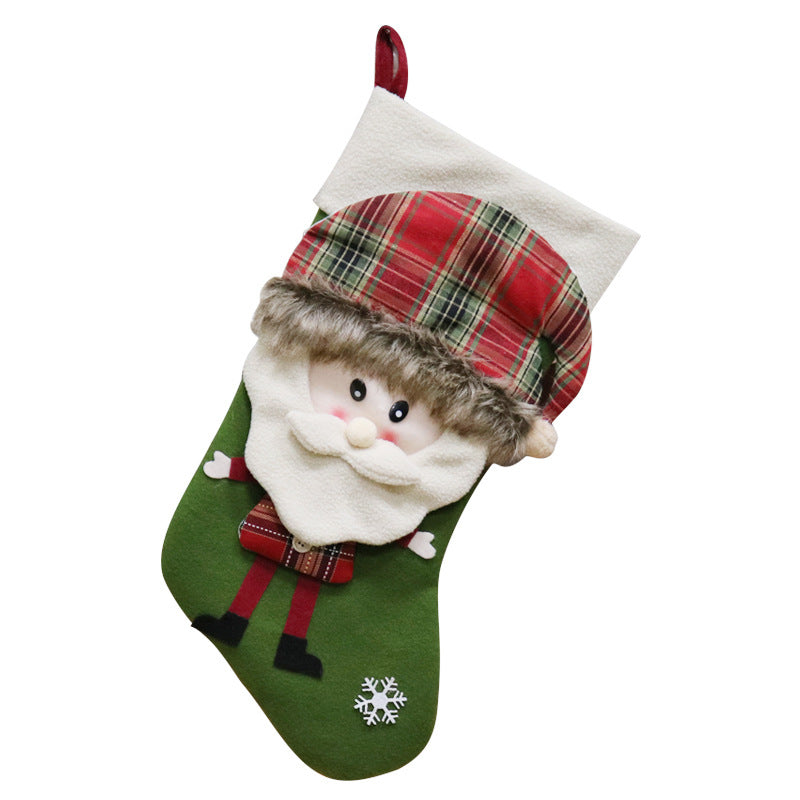 Festive Christmas stocking featuring a plush Santa face with a plaid hat, white beard, and furry edge on a green background with a snowflake detail at the toe.