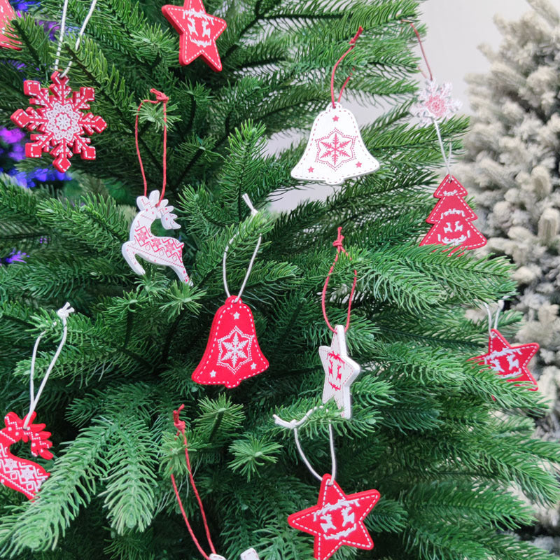 Christmas tree adorned with red and white ornaments, including stars, bells, snowflakes, reindeer, and trees, creating a festive holiday atmosphere.