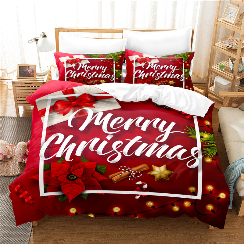 A festive Christmas-themed bedding set featuring "Merry Christmas" text in white on a red background with poinsettias, gift boxes, cinnamon sticks, and star decorations.