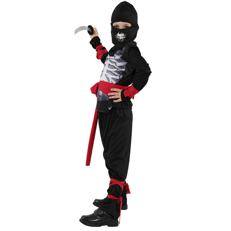 Child in a black ninja costume with a skeleton design, red belts, and holding a plastic dagger. The mask has a grinning skull face.