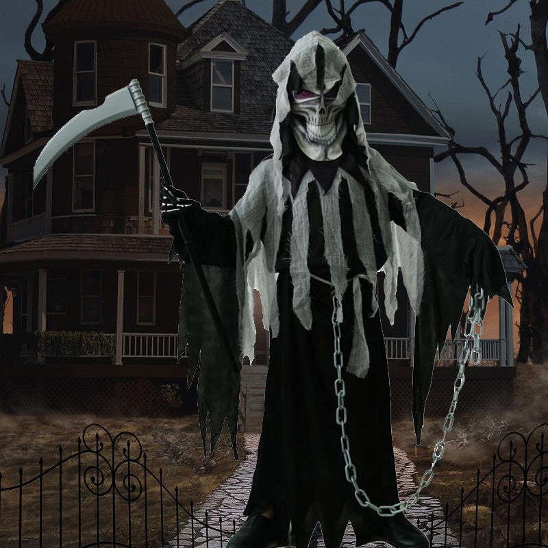 A grim reaper figure stands in front of a gloomy, haunted house, holding a scythe and chains. The scene is eerie, with a foggy path and bare trees at dusk.