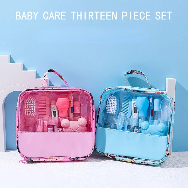 Two baby care kits, one pink and one blue, each with 13 pieces including combs, brushes, and thermometers, displayed in transparent bags under the text "Baby Care Thirteen Piece Set."
