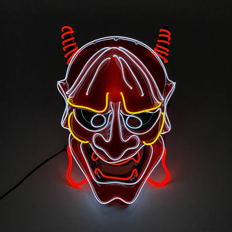 Neon sign of a stylized red devil face with horns. The face outlines are illuminated in white, with yellow details around the eyes and mouth, and red accents highlighting the features.
