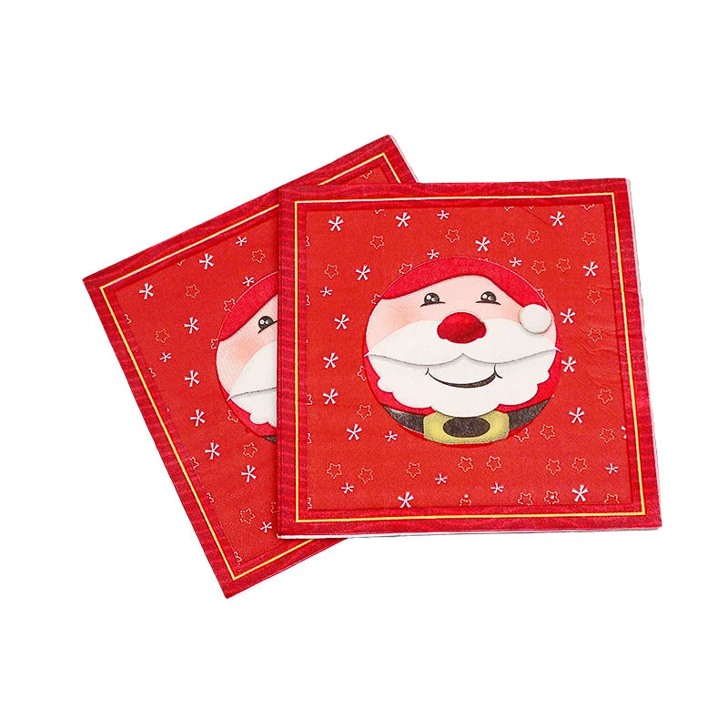 Two red Christmas napkins featuring a smiling Santa Claus in the center, surrounded by white snowflakes and stars, with a gold border accent.