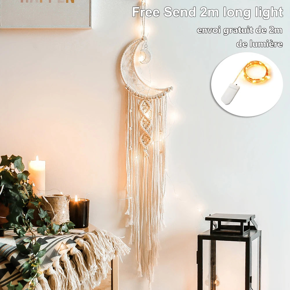 Macrame wall hanging in crescent moon shape with string lights, next to candles, plants, and a lantern. Text mentions "Free 2m long light." Cozy, boho decor.