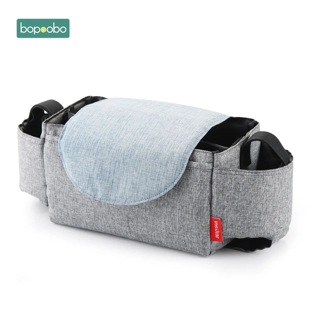 Gray stroller organizer bag with a light blue fold-over flap, featuring multiple pockets and a small red label. The brand logo "bopoobo" is visible in the top left corner.