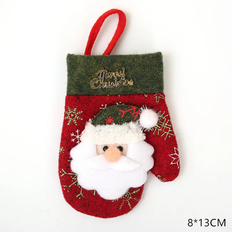 Red Christmas mitten with Santa face, green trim reading "Merry Christmas," snowflake patterns, and a hanging loop. Dimensions: 8x13 cm.