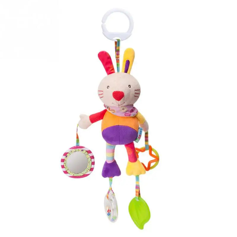Colorful rabbit baby toy with a ring attachment, featuring a plush body, mirror, clear rattle with beads, and green leaf-shaped teether. Designed for sensory play.