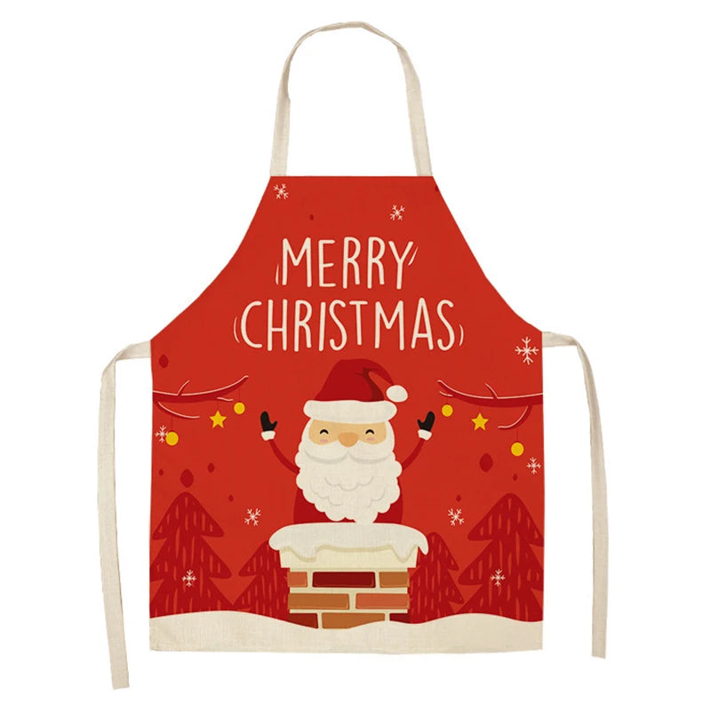 Red Christmas apron featuring Santa in a chimney, surrounded by snowflakes and trees, with "Merry Christmas" text above him.