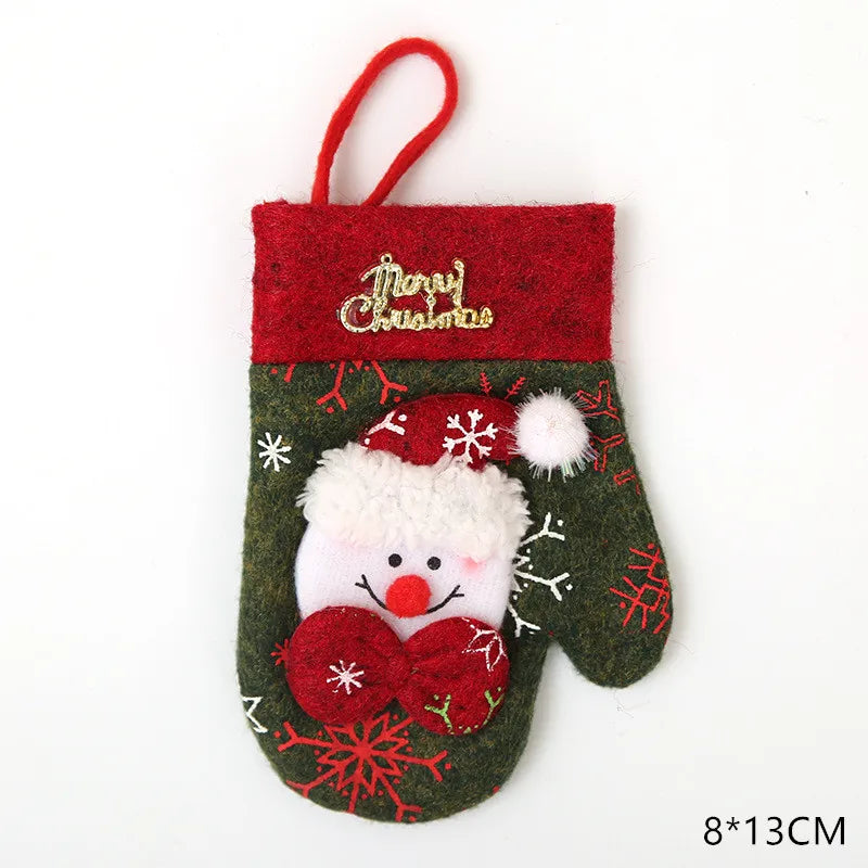 Festive Christmas mitten with Santa face, red cuff, and snowflake motifs. Gold "Merry Christmas" text adorns the top. Size 8x13cm.