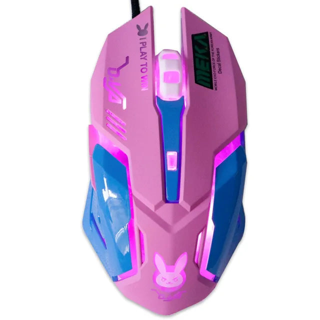 Pink gaming mouse with blue accents and purple LED lighting. Features "I play to win" text and a bunny logo, designed for ergonomic gameplay with sharp, futuristic angles.
