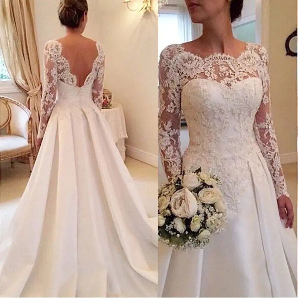 Front and back views of a woman in an elegant wedding dress, featuring lace sleeves and a full skirt. She holds a bouquet of white flowers and stands in a warmly lit room.
