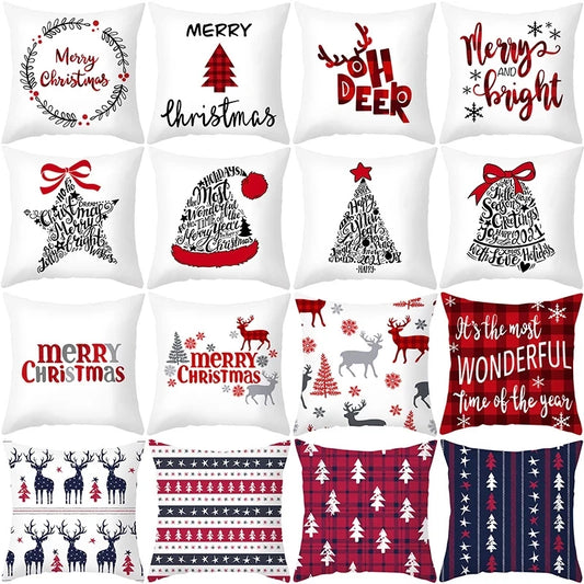 Sixteen festive Christmas pillows arranged in a grid, featuring various designs like reindeer, trees, and holiday phrases in red, white, and black tones on a white background.