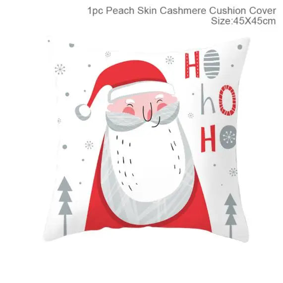 Cushion cover featuring a cheerful Santa illustration with "Ho Ho Ho" text. Santa wears a red hat and coat, surrounded by snowflakes and trees. Measures 45x45cm.