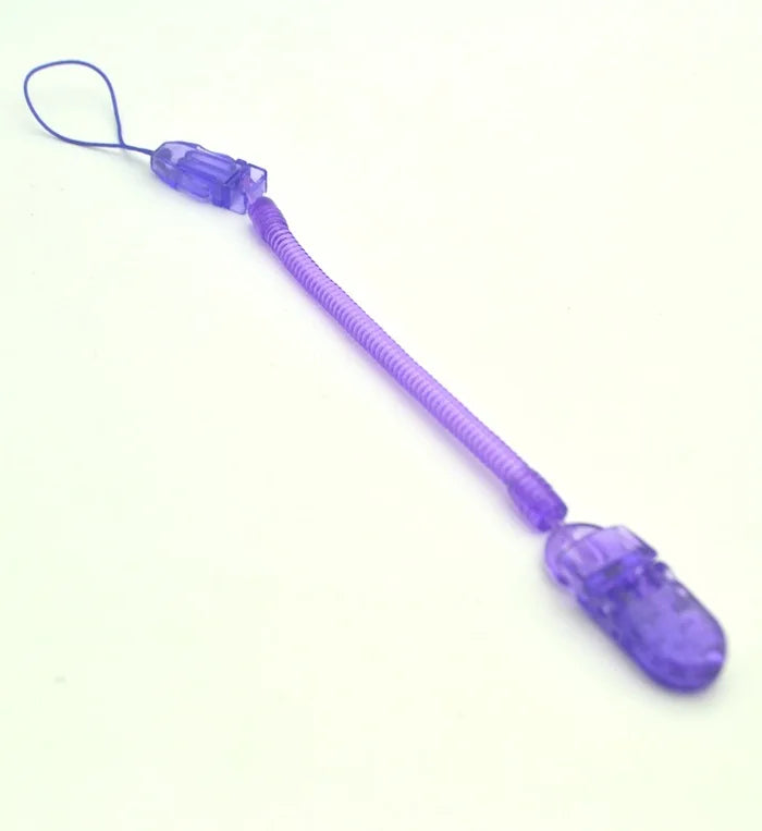 A purple spiral coil keychain with plastic clips on both ends lies on a white surface.