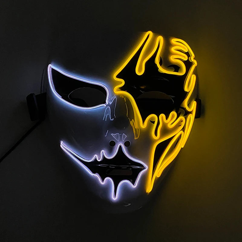 A half-white, half-black mask with glowing neon outlines in white and yellow, featuring bat and spider web motifs, set against a dark background.
