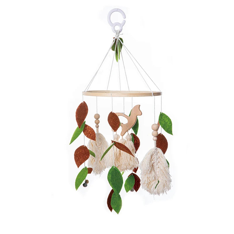 Wooden baby mobile with felt leaves, a squirrel shape, and tassels, hanging from a hoop using strings. The item has a mix of green, brown, and beige colors.