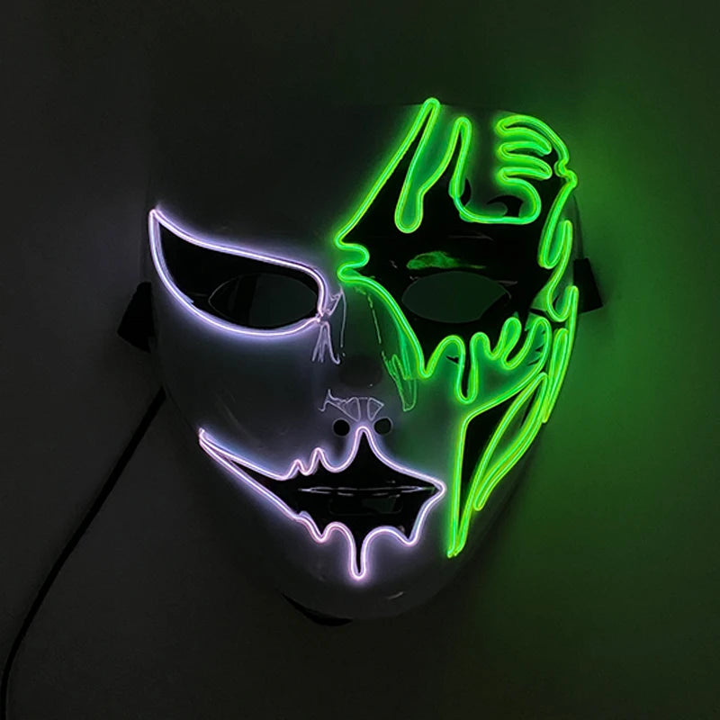 A white mask with neon lights features a split design: one side glowing purple and the other green, creating an eerie, glowing effect in the dark.