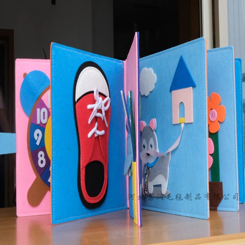 Colorful felt activity book for children, featuring a page with a red shoe for lacing practice, a clock, a fabric mouse, a flower, and a felt house with a blue roof.
