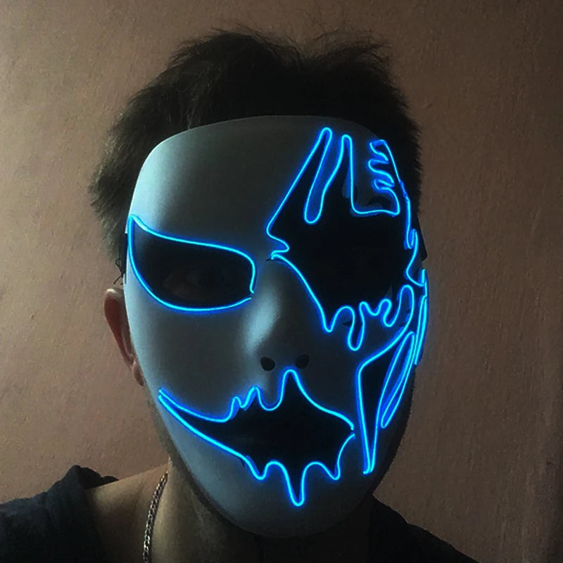 Person wearing a white mask with blue neon outlines, featuring abstract designs around the eyes and mouth, against a dimly lit background.