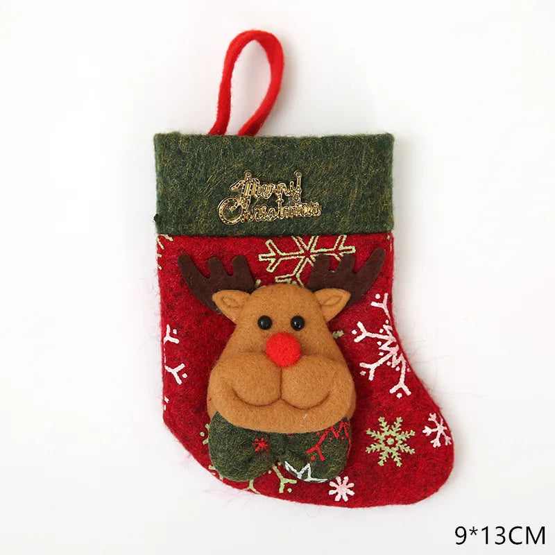 Red Christmas stocking with green trim, decorated with a reindeer face and snowflake patterns. Features "Merry Christmas" text. Size is 9x13 cm.