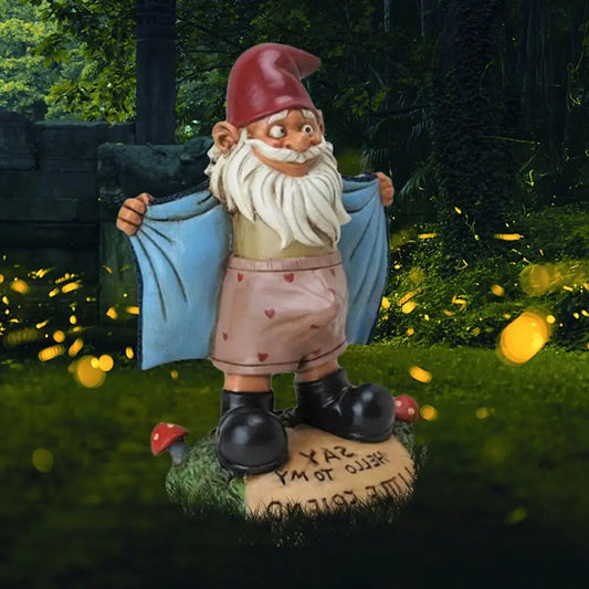 Garden gnome with a red hat, bushy beard, and blue coat opens to reveal heart-patterned shorts. Stands on a mushroom-dotted base with glowing fireflies in the forest background.