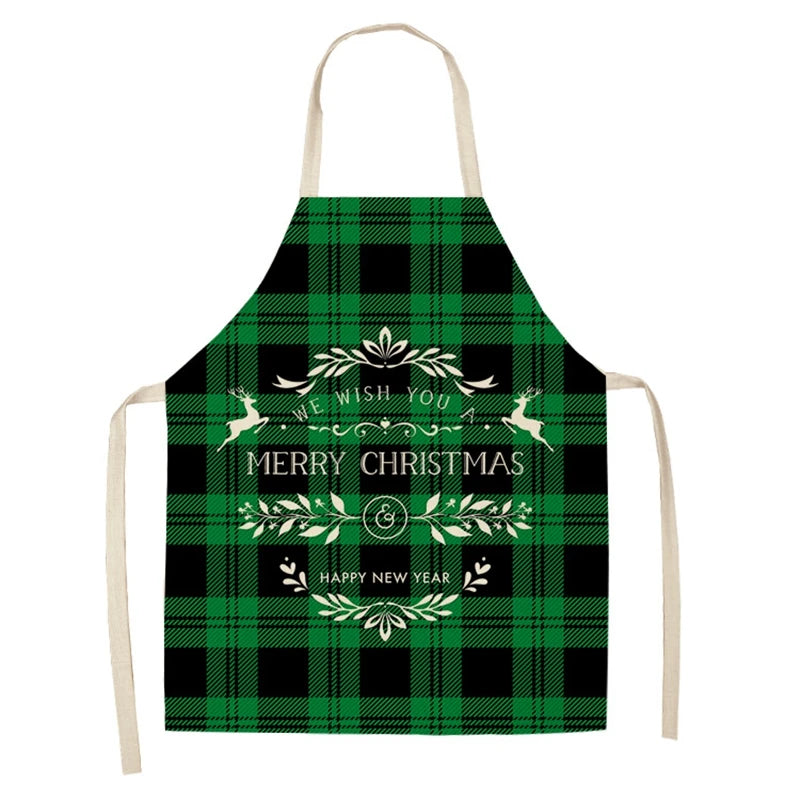 Green plaid apron with a festive design featuring reindeer and wreaths. The text reads, "We wish you a Merry Christmas & Happy New Year." Cream straps complete the look.